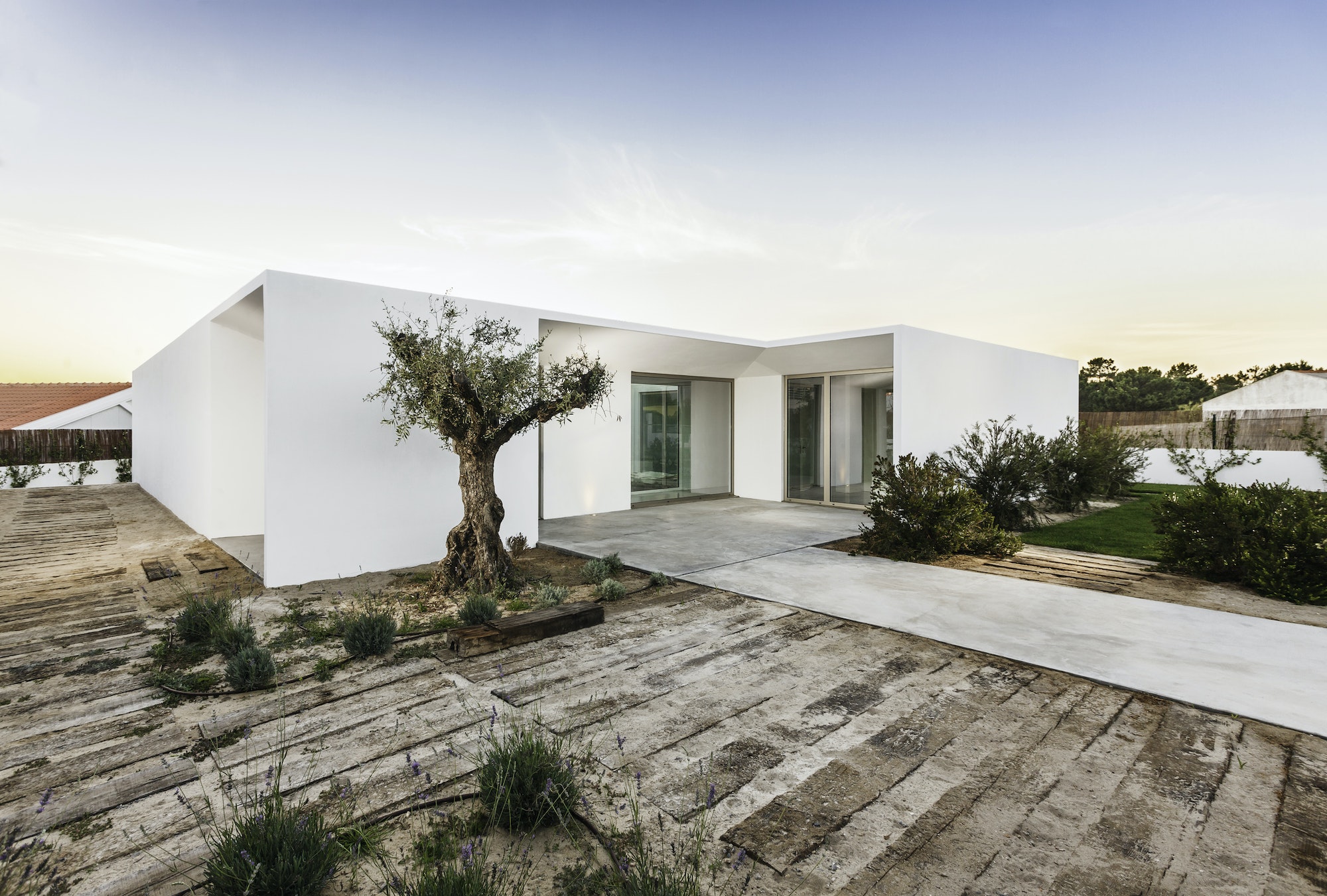 Modern house entrance with garden and wooden deck