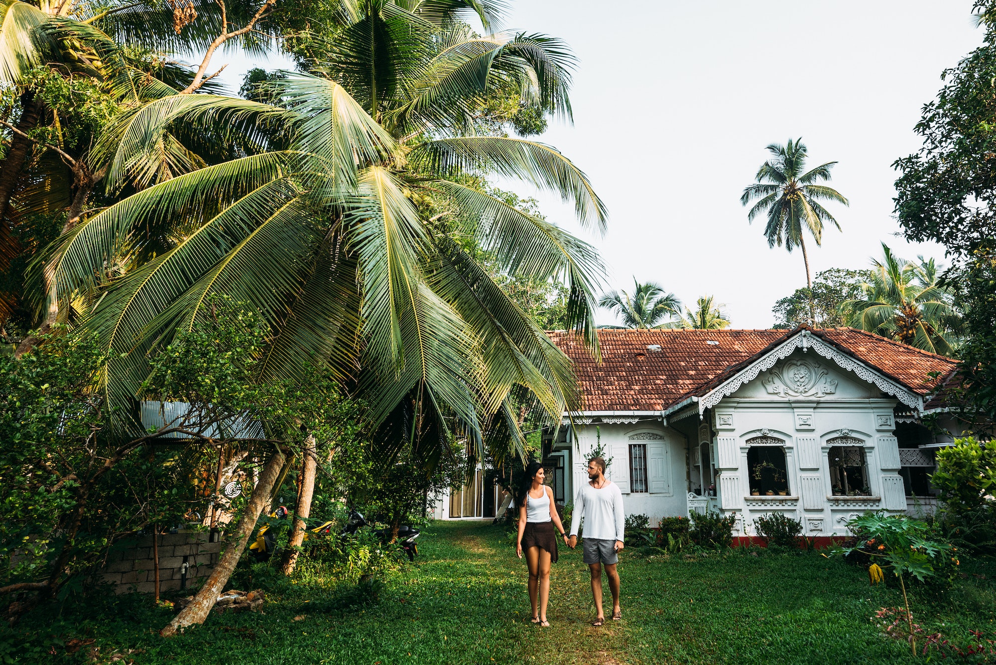 The couple in the home garden. Man and woman rent a house. A couple in love travels